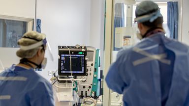 Health workers wearing full personal protective equipment (PPE) on the intensive care unit (ICU) at Whiston Hospital in Merseyside